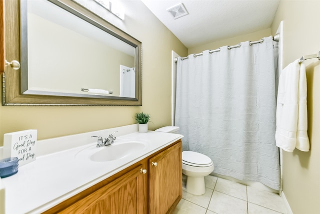 bathroom featuring toilet, vanity, and tile patterned floors