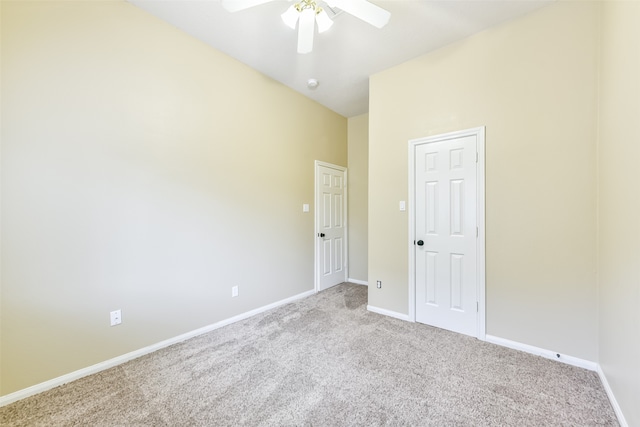 carpeted empty room featuring ceiling fan