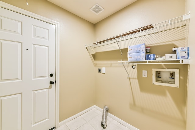 laundry room with hookup for a washing machine, light tile patterned floors, and hookup for an electric dryer