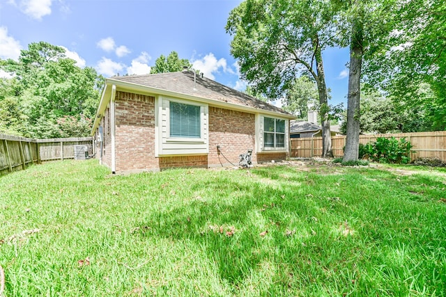 rear view of property with a yard