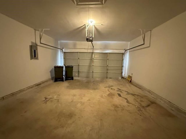 garage with a garage door opener and electric panel