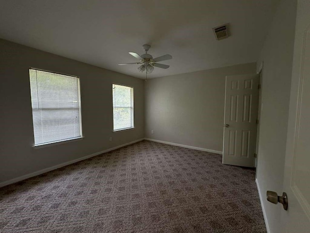 unfurnished room featuring ceiling fan and carpet flooring