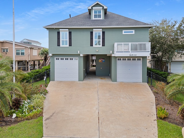 view of front of home featuring a balcony and a garage