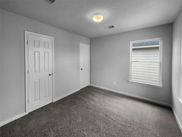 carpeted spare room featuring a wealth of natural light