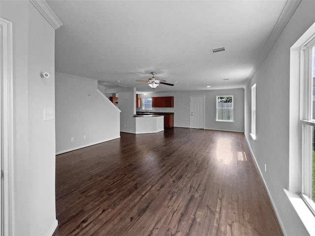 unfurnished living room featuring ceiling fan, ornamental molding, and dark hardwood / wood-style floors