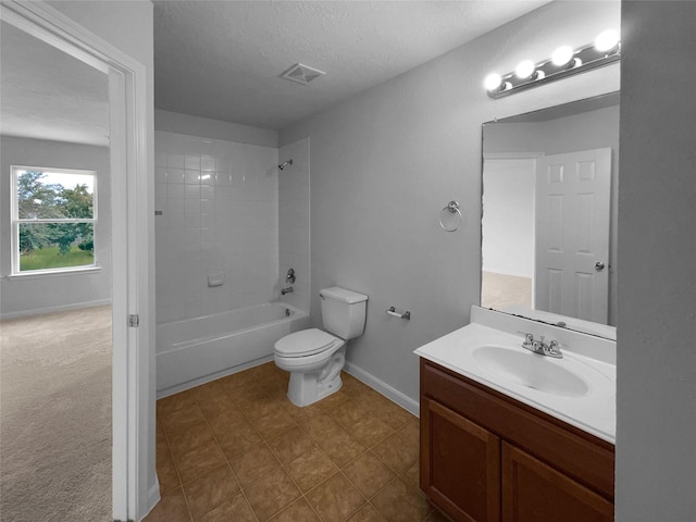 full bathroom featuring toilet, a textured ceiling, tiled shower / bath combo, and vanity