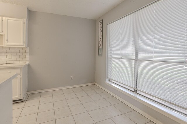 unfurnished dining area featuring light tile patterned floors