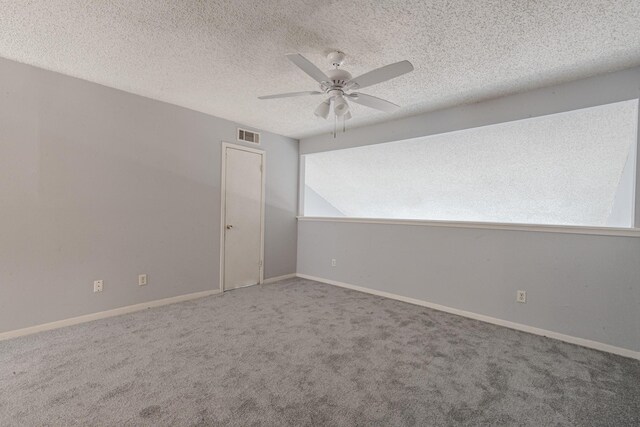 unfurnished room with carpet floors, ceiling fan, and a textured ceiling