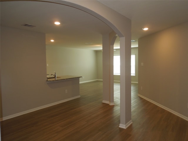 spare room with dark wood-type flooring and sink