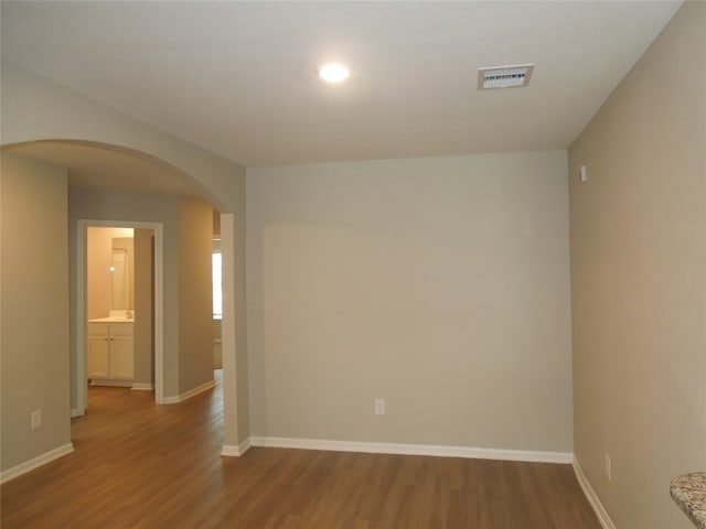 empty room with hardwood / wood-style flooring