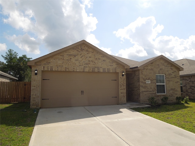 single story home featuring a garage and a front lawn