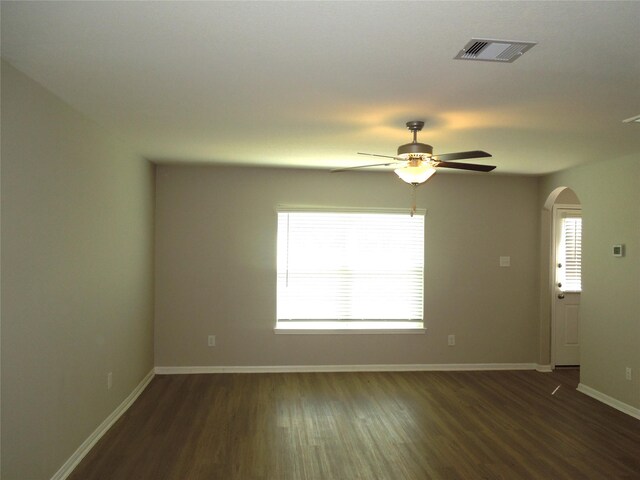 empty room with dark hardwood / wood-style floors and ceiling fan