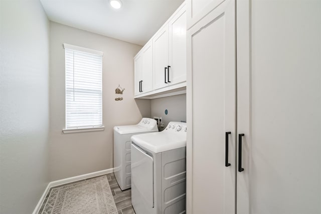 washroom with cabinets and washer and clothes dryer