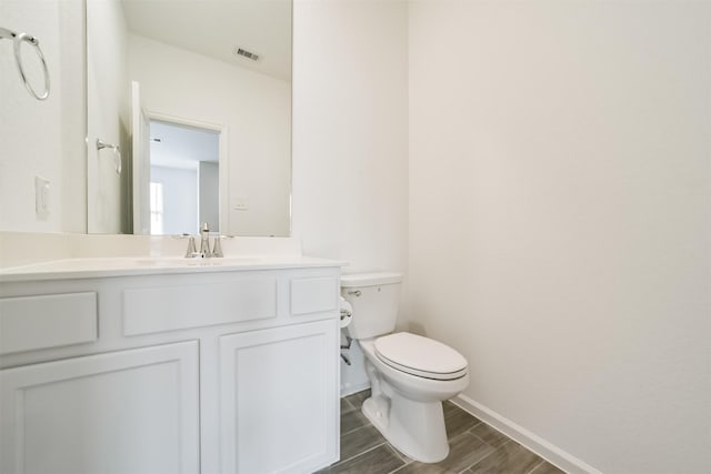 bathroom featuring toilet and vanity