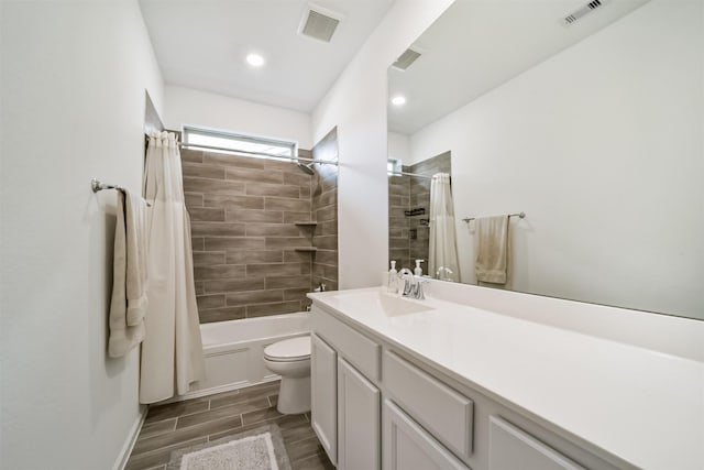 full bathroom featuring toilet, vanity, and shower / tub combo with curtain