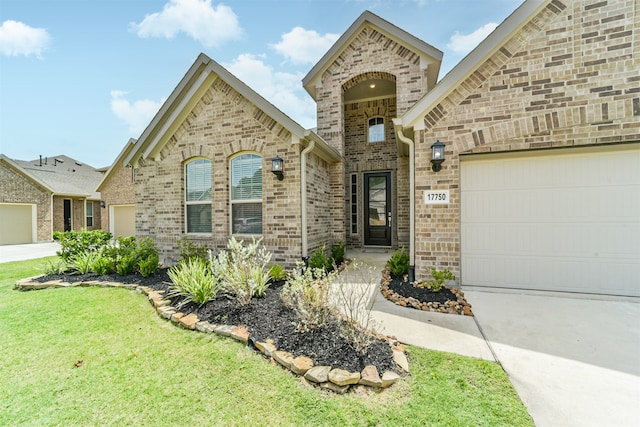 view of front of house with a garage and a front lawn