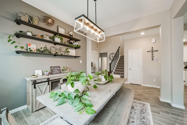 interior space with decorative light fixtures, white cabinetry, and a notable chandelier