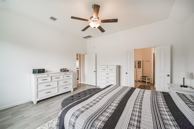 bedroom with vaulted ceiling, ceiling fan, and light hardwood / wood-style flooring