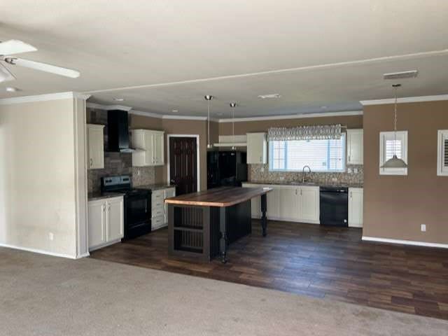 kitchen with black dishwasher, electric stove, tasteful backsplash, white cabinetry, and dark hardwood / wood-style flooring