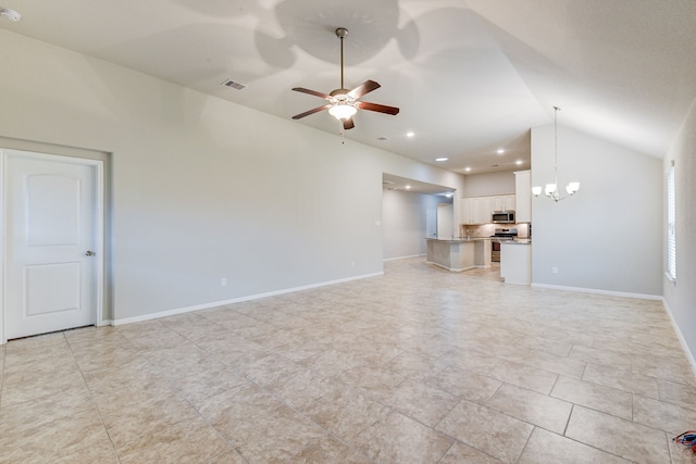 unfurnished living room featuring lofted ceiling and ceiling fan with notable chandelier