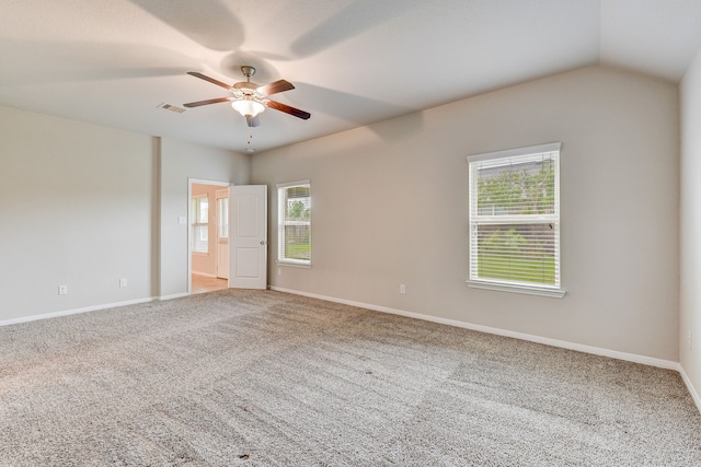 spare room featuring ceiling fan, plenty of natural light, vaulted ceiling, and carpet