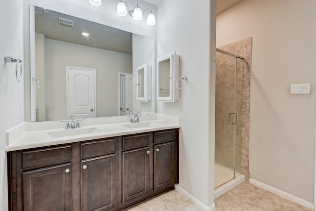 bathroom featuring vanity, tile patterned floors, and a shower with door