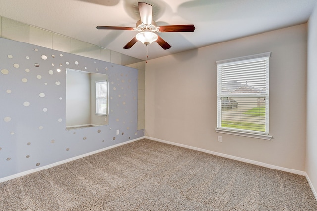 carpeted empty room featuring ceiling fan