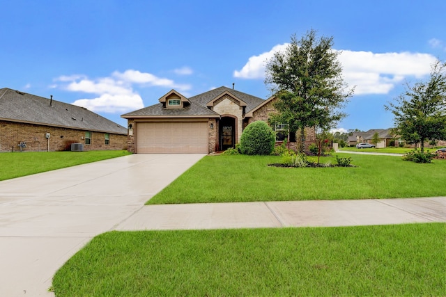 view of front of property with a garage, a front lawn, and central air condition unit