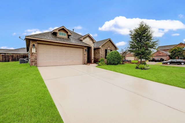 view of front of property with cooling unit, a garage, and a front lawn