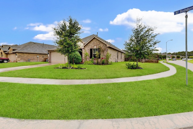 view of front of property with a garage and a front lawn