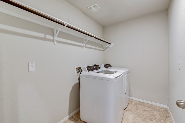 washroom with washer and dryer