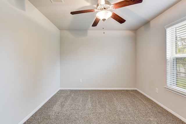 empty room with ceiling fan and carpet