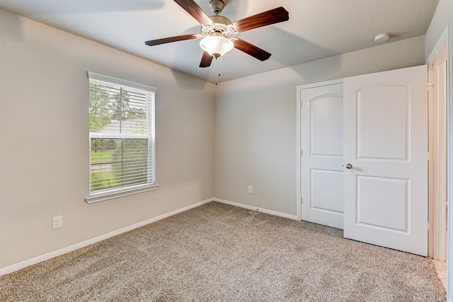 unfurnished bedroom with light carpet and ceiling fan