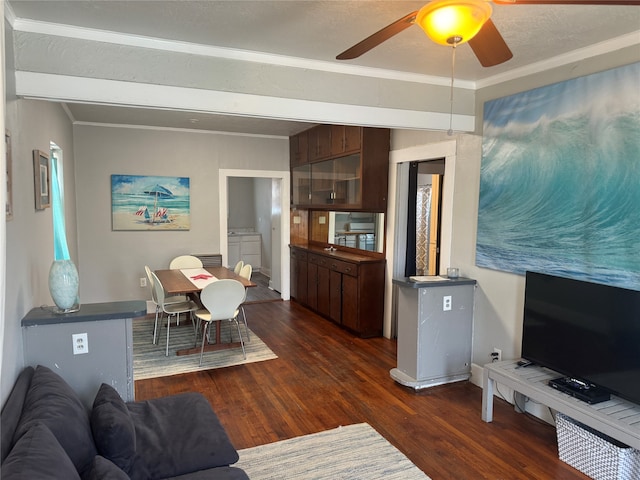 living room featuring dark hardwood / wood-style floors, ceiling fan, and ornamental molding