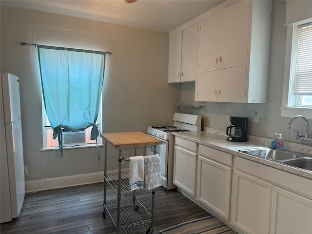 kitchen featuring white appliances, white cabinets, sink, decorative backsplash, and dark hardwood / wood-style floors