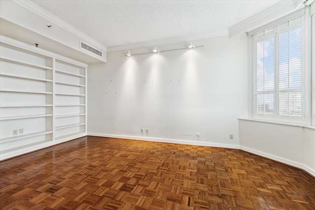 unfurnished room with plenty of natural light, dark parquet flooring, built in features, and a textured ceiling