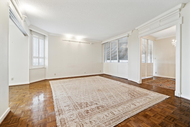 empty room featuring crown molding, a textured ceiling, a notable chandelier, and dark parquet floors