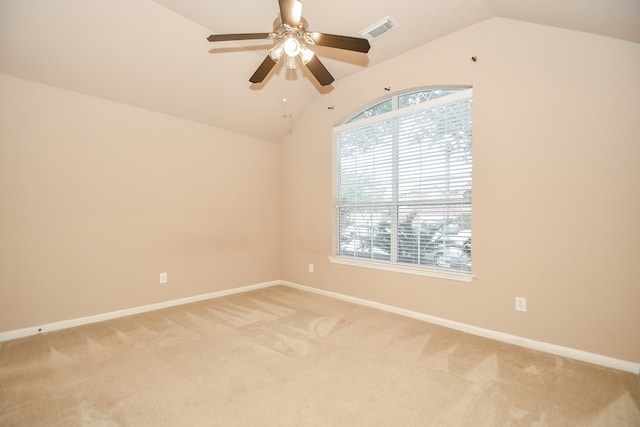 spare room with carpet, ceiling fan, and vaulted ceiling