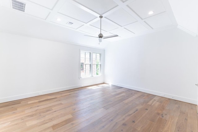 spare room with ceiling fan, ornamental molding, coffered ceiling, and light hardwood / wood-style floors