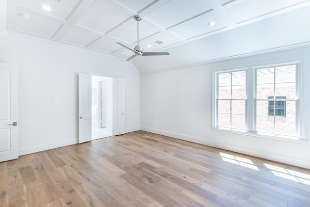 empty room featuring light wood-type flooring, ceiling fan, coffered ceiling, and beamed ceiling