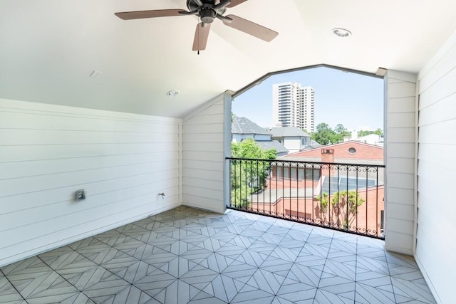 interior space with ceiling fan and vaulted ceiling