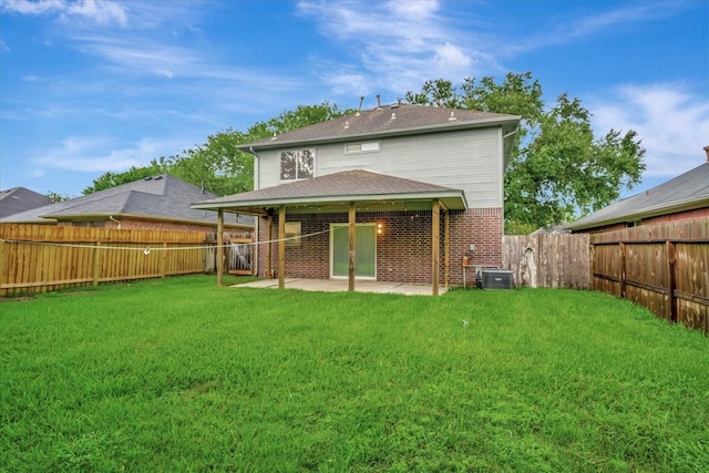 rear view of house featuring a yard, a patio area, and central air condition unit