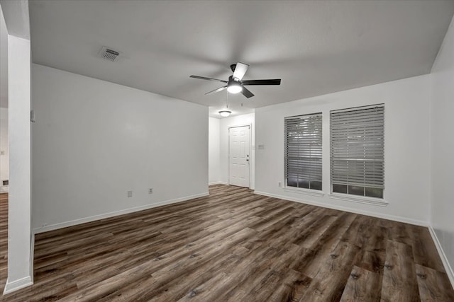 unfurnished living room with ceiling fan and dark wood-type flooring