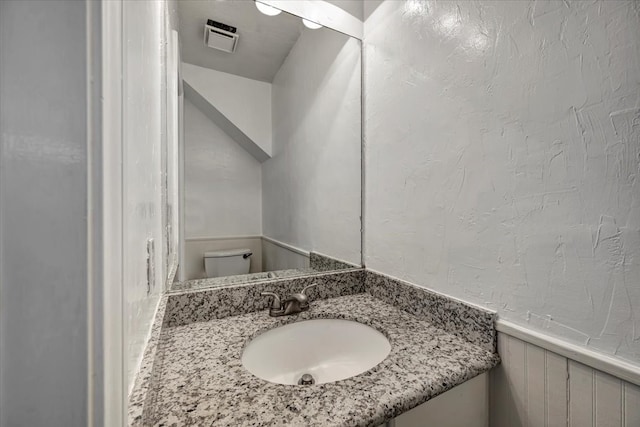 bathroom with vanity and toilet