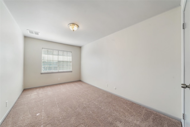 spare room featuring light colored carpet