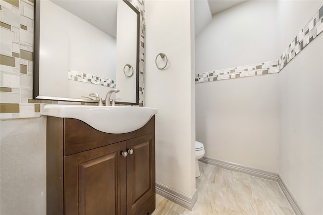 bathroom with vanity, tile patterned flooring, and toilet