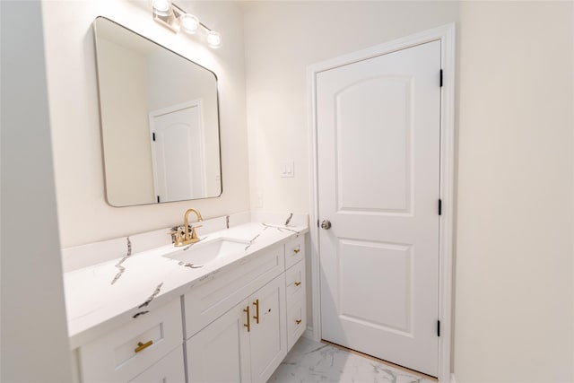 bathroom with marble finish floor and vanity