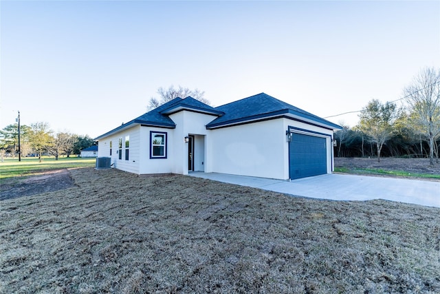 ranch-style home with central air condition unit, driveway, an attached garage, and stucco siding