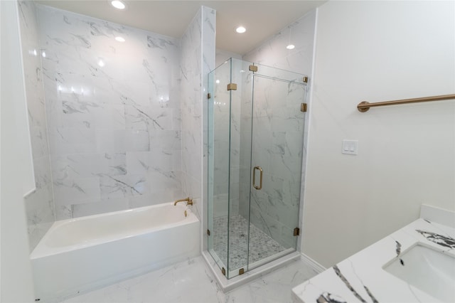 bathroom featuring a stall shower, marble finish floor, a bathtub, a sink, and recessed lighting