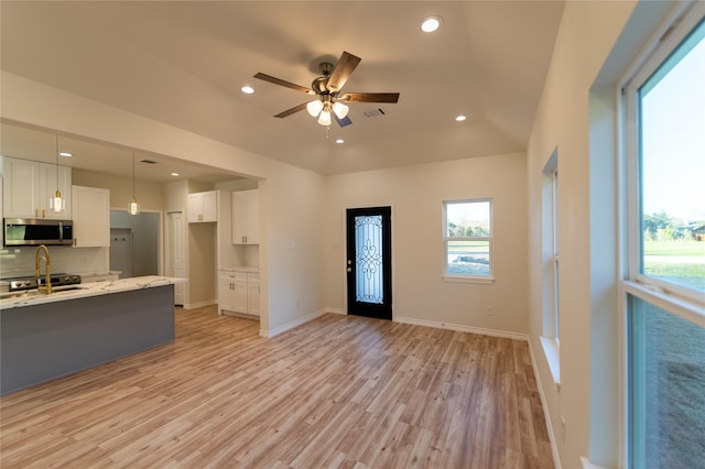 kitchen featuring recessed lighting, visible vents, white cabinets, light wood-type flooring, and stainless steel microwave